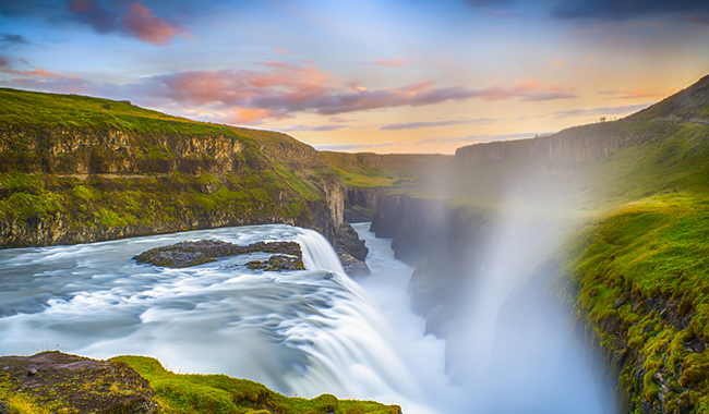 Gullfoss Waterfall in Iceland on a sunny day with green grass all